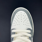 White perforated toe box with white laces on light blue low-top sneakers