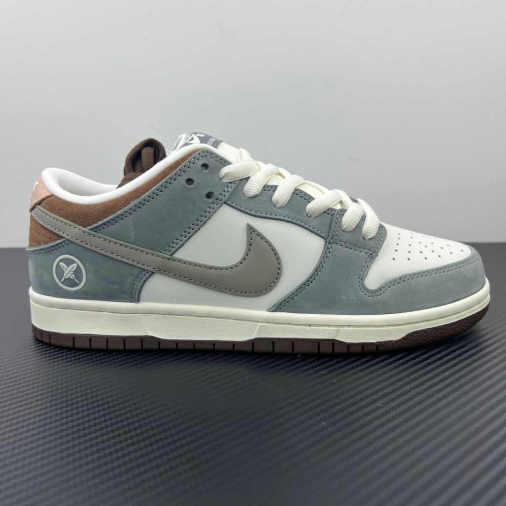 Light blue low-top sneakers with white laces, Nike swoosh, and perforated toe