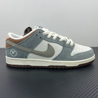 Light blue low-top sneakers with white laces, Nike swoosh, and perforated toe