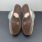 Two low-top sneaker soles with brown traction tread patterns