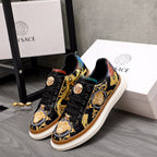Versace sneakers pair, black leather with gold baroque print and multicolor heel accents