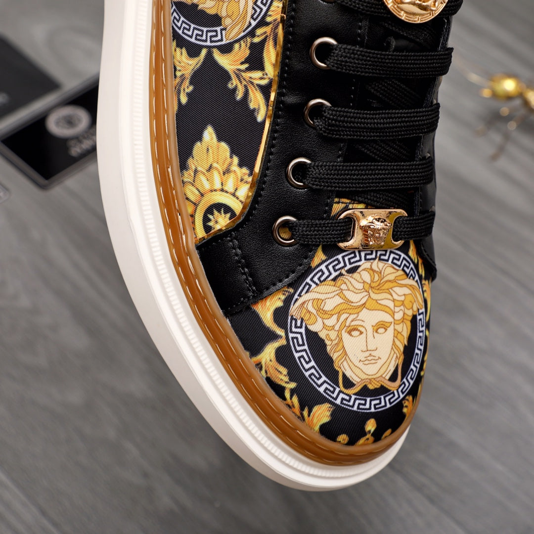 Versace sneakers detail, black lace-up with gold medallion artwork and gold hardware