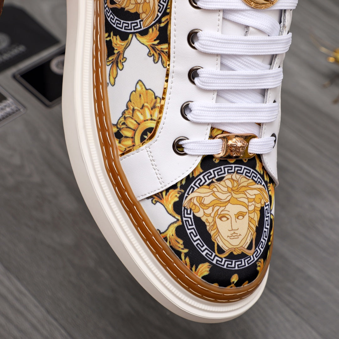 Low-top sneaker side detail: white leather, gold lace hardware and baroque medallion print