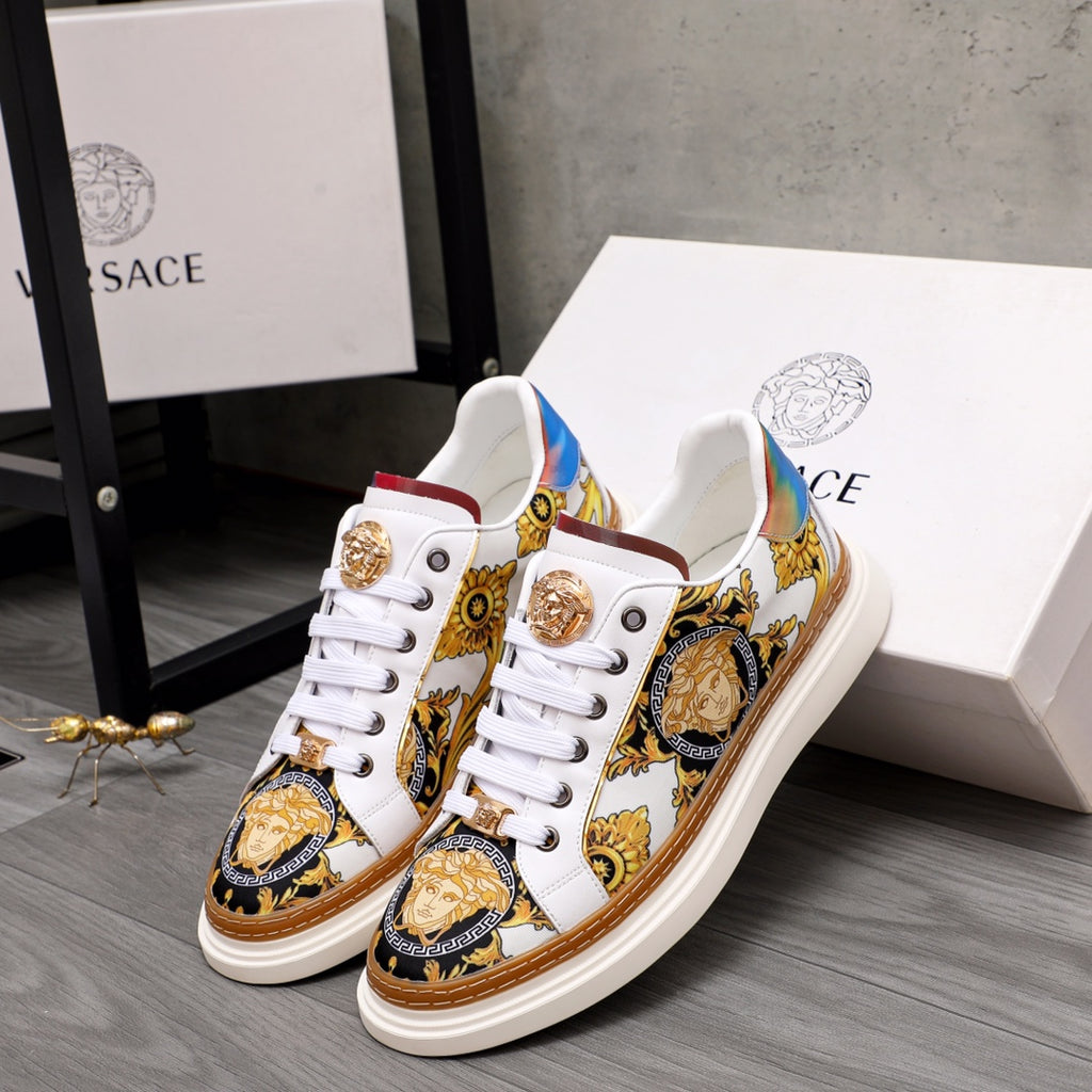 Low-top sneakers in white with gold medallions and baroque gold, blue and brown patterns