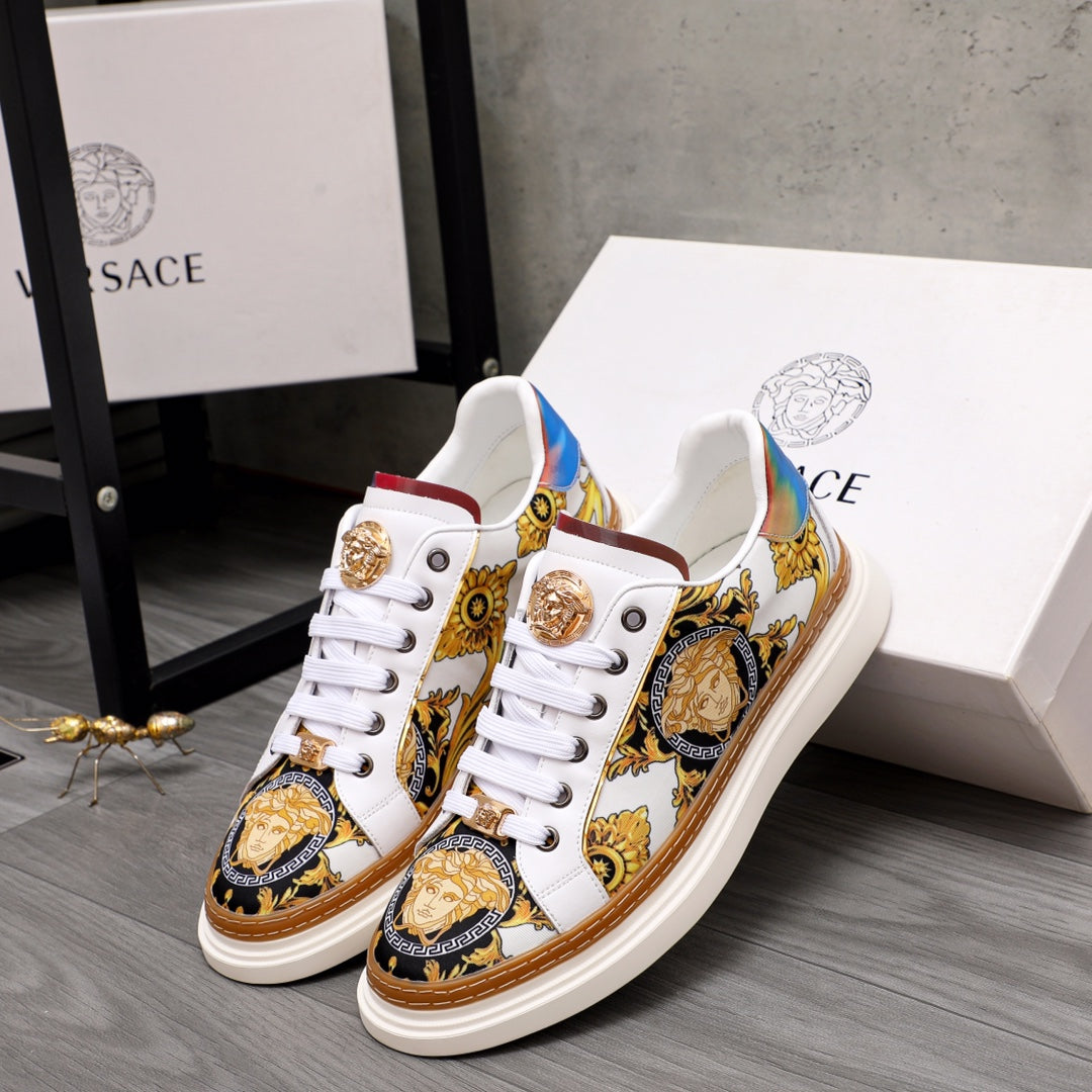 Low-top sneakers in white with gold medallions and baroque gold, blue and brown patterns