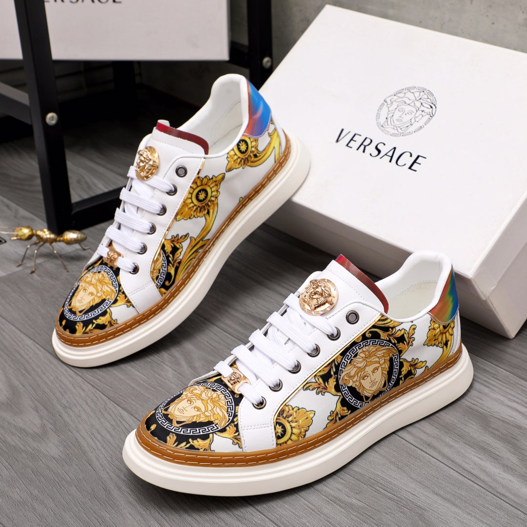 Low-top sneakers in white with gold medallion, ornate gold and blue patterned panels