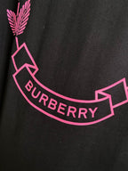 Black T-shirt detail with pink laurel graphic and curved BURBERRY text