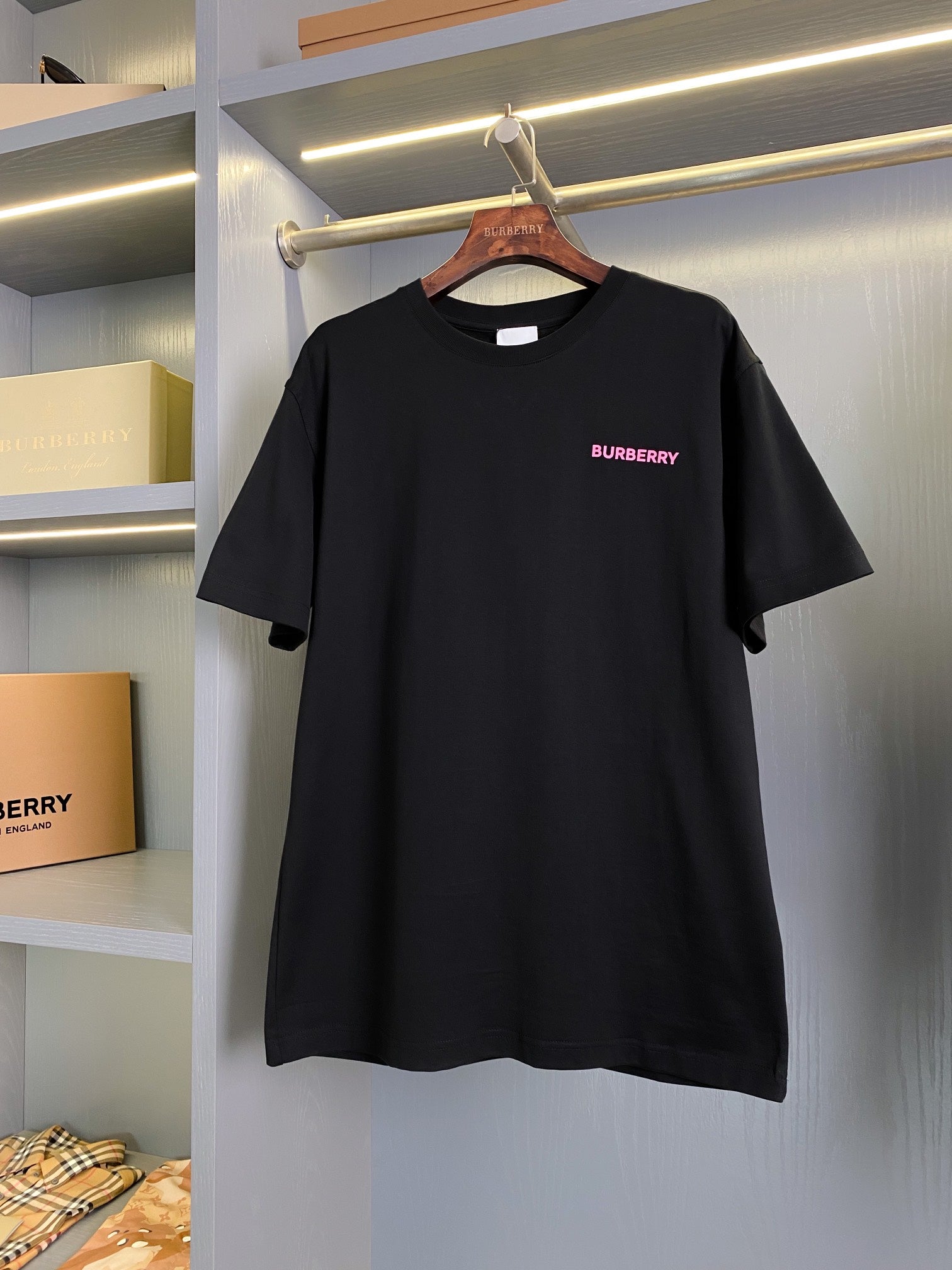 Black short-sleeve T-shirt with small pink BURBERRY logo on chest