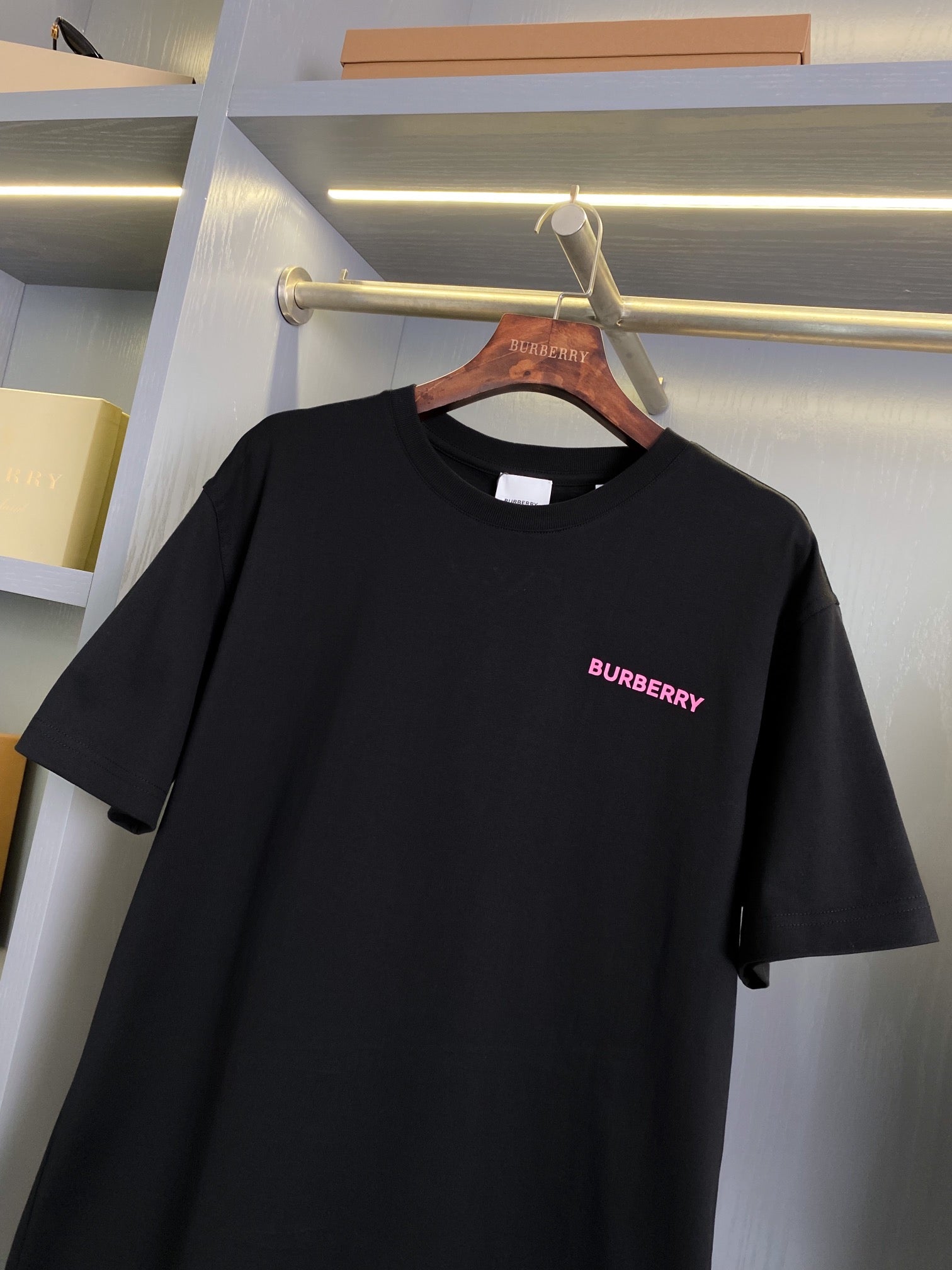 Black short-sleeve T-shirt with pink BURBERRY logo near right chest