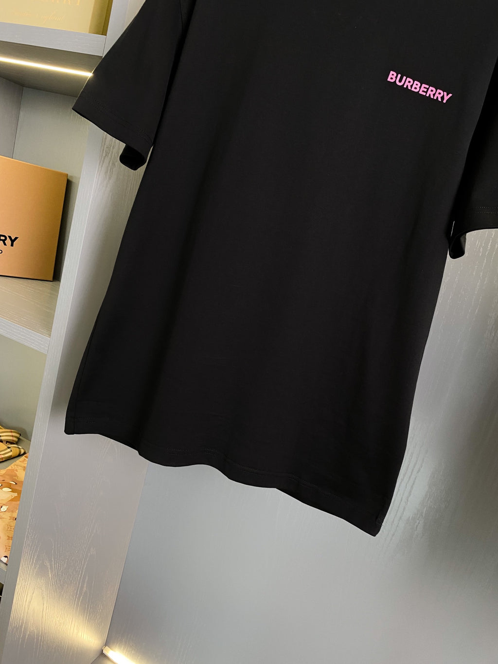 Black short-sleeve T-shirt with small pink BURBERRY logo on chest