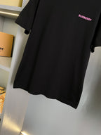 Black short-sleeve T-shirt with small pink BURBERRY logo on chest