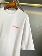 White short-sleeve T-shirt with pink Burberry text logo on chest, crew neck