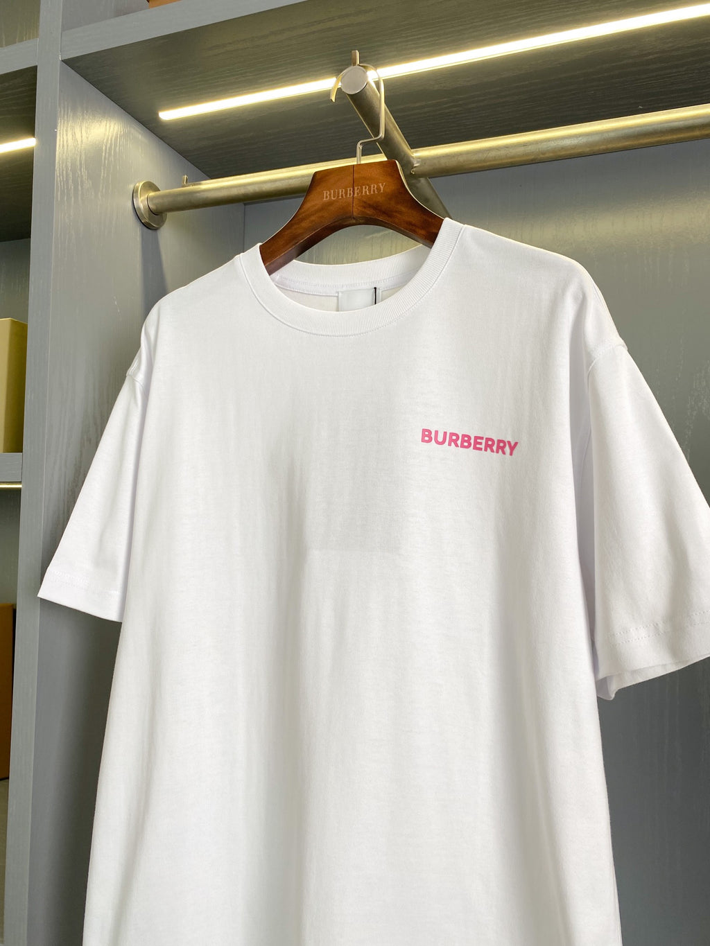 White short-sleeve T-shirt with small pink Burberry logo on chest, crew neck