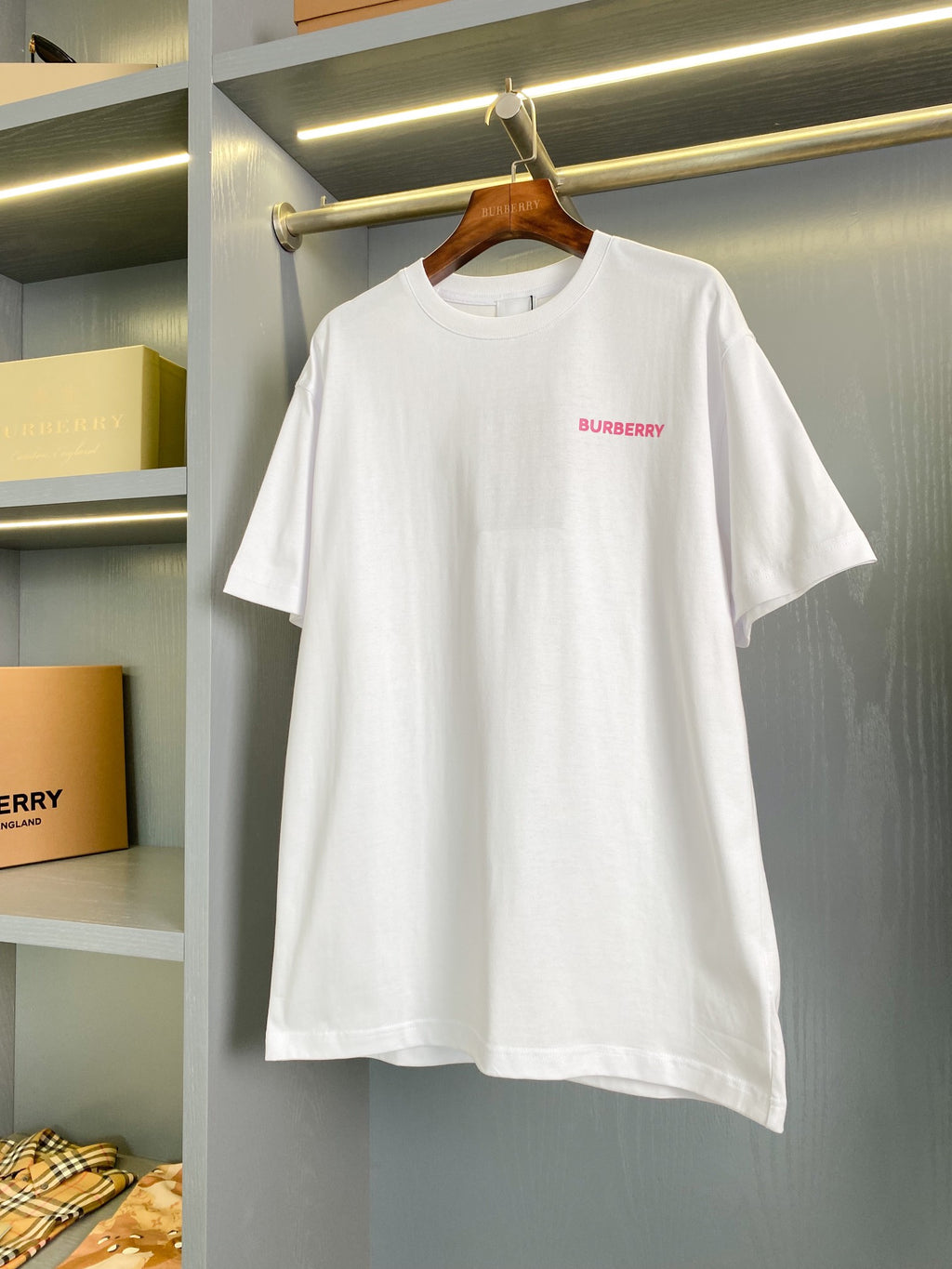 White short-sleeve T-shirt with small pink Burberry logo at chest, crew neck
