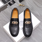 Men's Versace black leather loafers with embossed texture and gold crest buckle