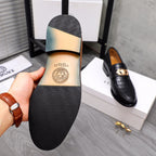 Men's Versace loafer sole with embossed pattern, showing tan leather insole