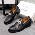 Men's Versace black leather loafers with gold crest detail and textured upper