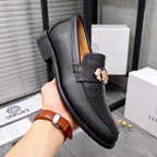Men's Versace black leather loafer with gold crest buckle and embossed strap