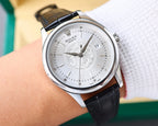 Rolex watch on wrist, black leather strap, silver case, white dial with date
