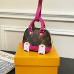 Louis Vuitton mini handbag charm with magenta handle, brown monogram base and pink panel