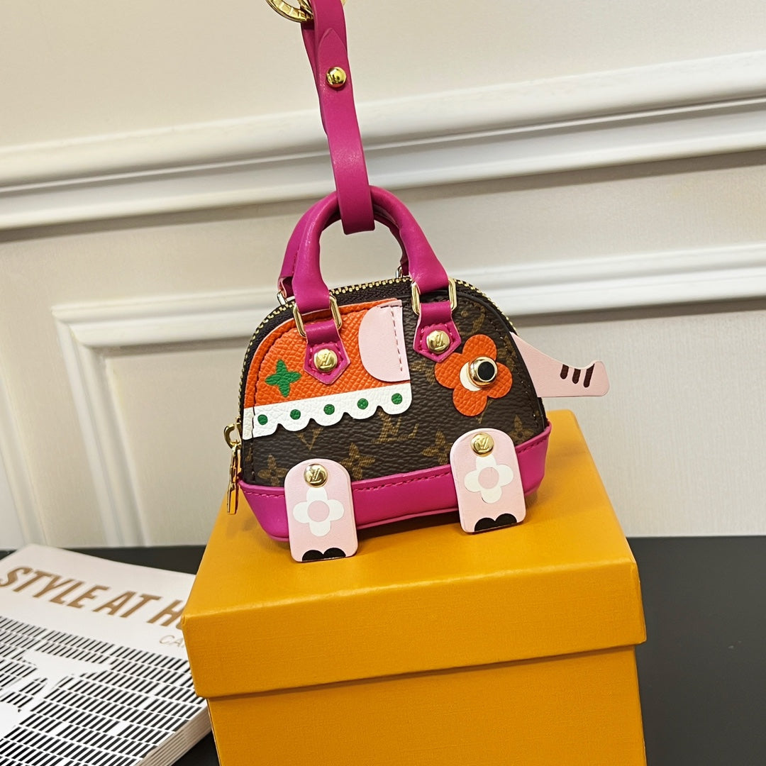 Small Louis Vuitton bag with brown monogram, pink handles, colorful front patches