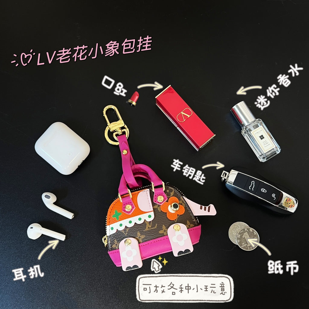 Small Louis Vuitton bag with brown monogram, pink accents, hanging charms and zipper