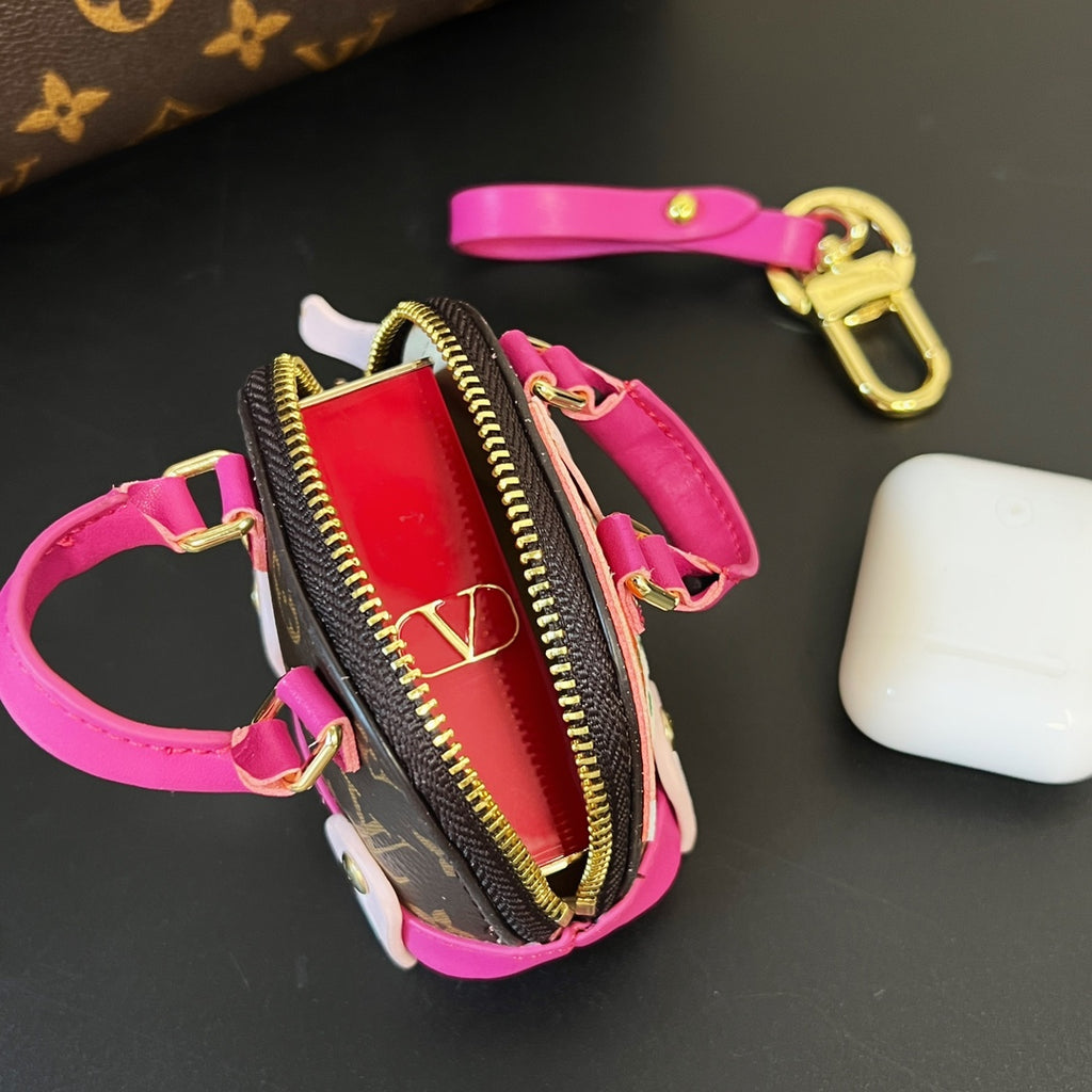 Louis Vuitton mini pouch with magenta strap, brown monogram trim, gold zipper and keyring