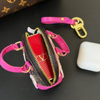 Louis Vuitton mini pouch with magenta strap, brown monogram trim, gold zipper and keyring