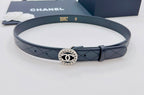 Chanel belt with dark navy leather strap and round CC emblem buckle at center