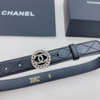 Chanel belt close-up: dark navy quilted strap with round CC logo buckle