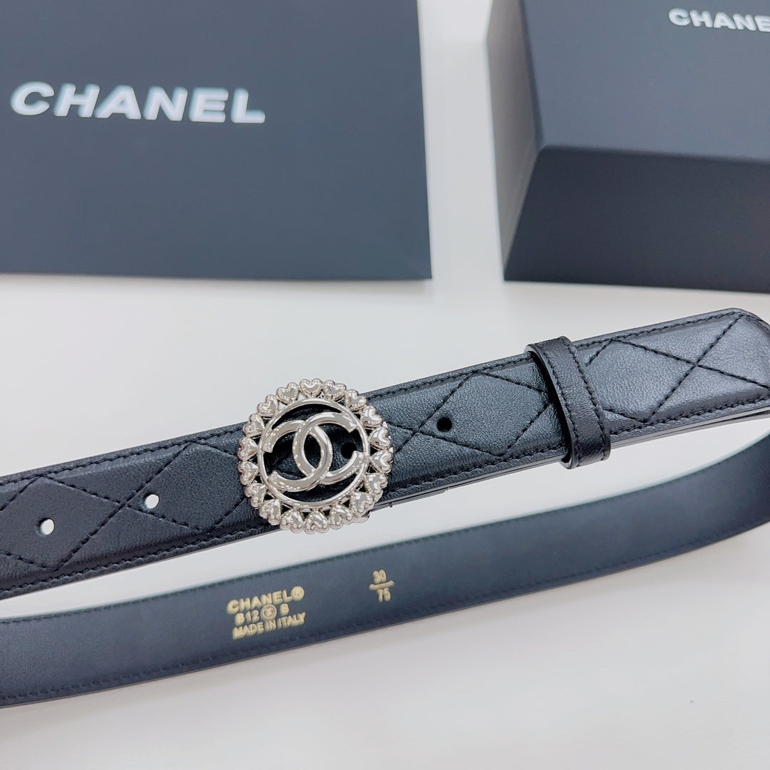 Chanel belt close-up: dark navy quilted strap with round CC logo buckle