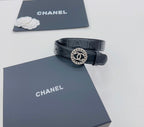 Chanel belt with dark navy leather strap and round CC buckle with textured border