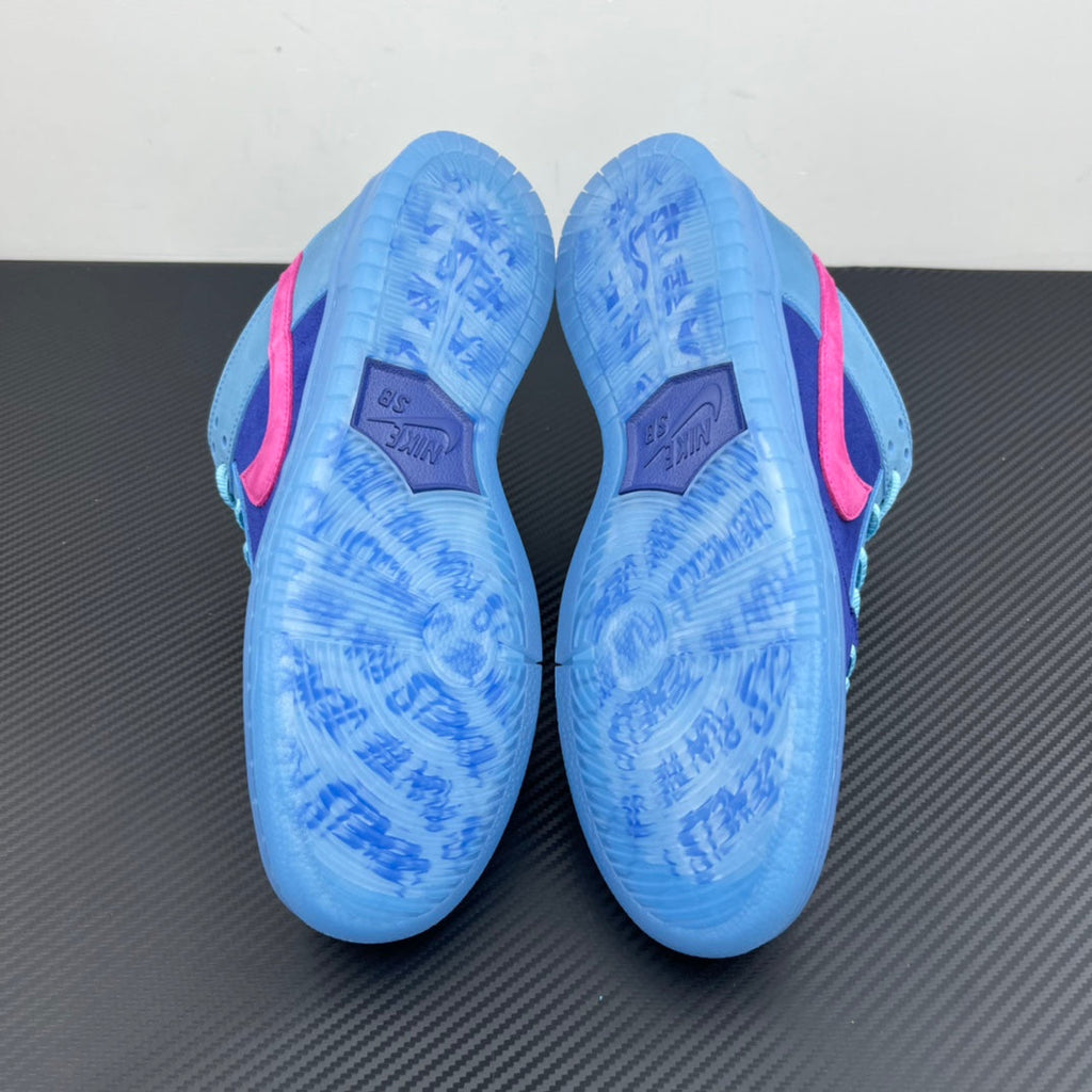 Low-top sneakers showing light-blue patterned outsoles with pink side accents.