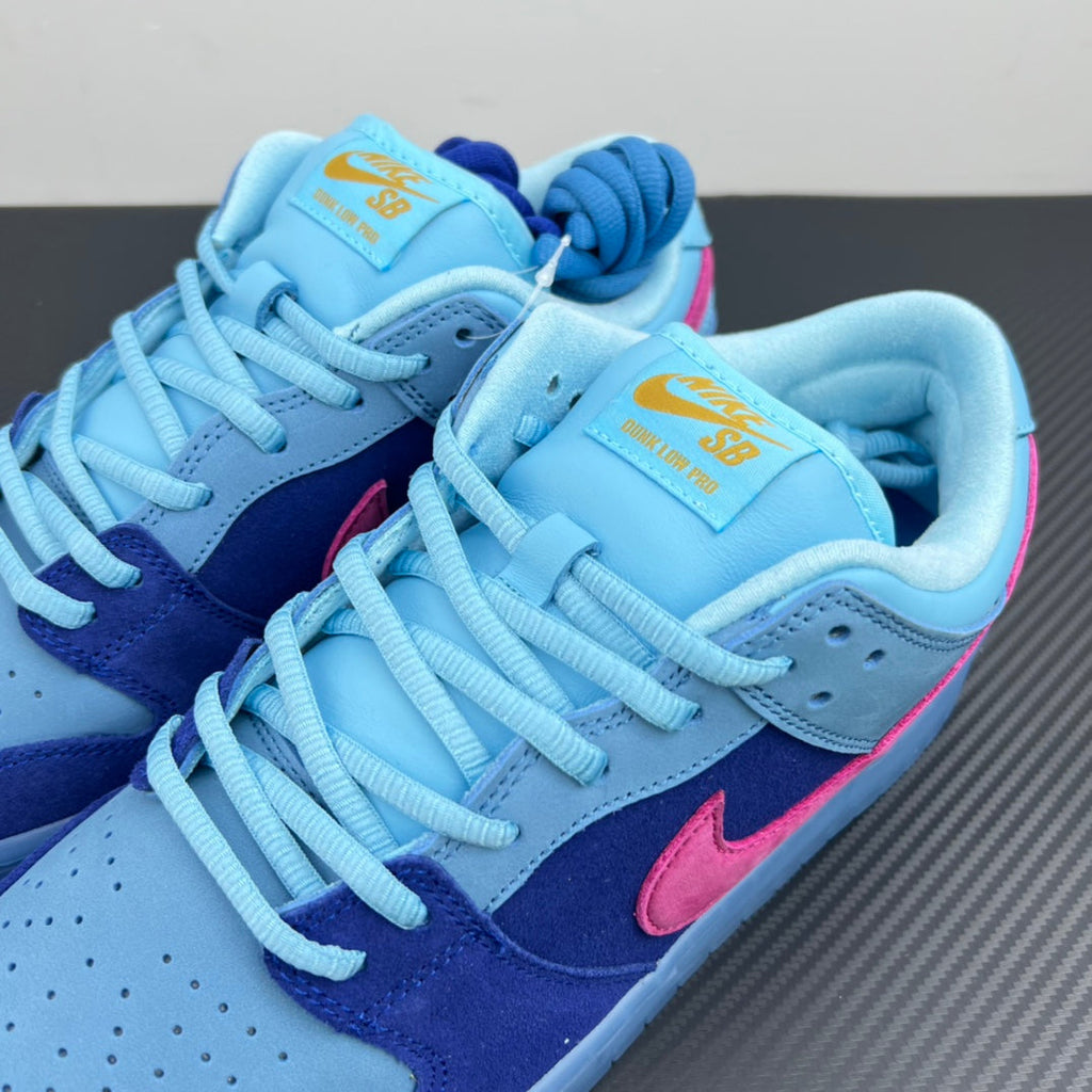 Pair of low-top sneakers with light-blue uppers, navy sides, and pink Nike swooshes.