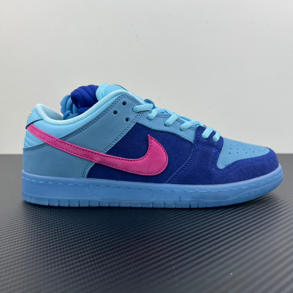Low-top sneakers with light blue panels, navy suede, pink swoosh, and blue laces.