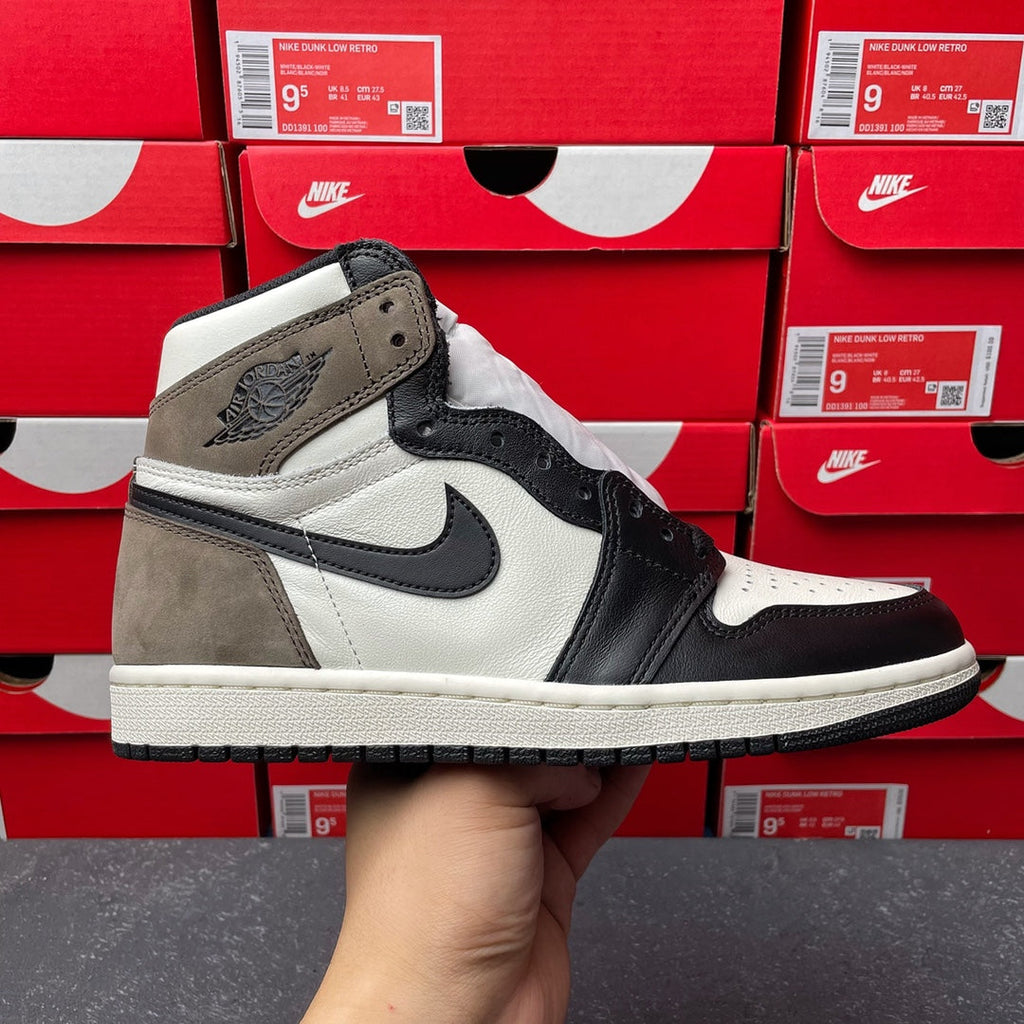 High-top sneakers with white leather, dark navy/black panels, and suede overlays