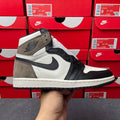 High-top sneakers with white leather, dark navy/black panels, and suede overlays