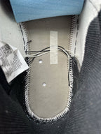 High-top sneakers, inner heel lining close-up, light fabric with stitching and label