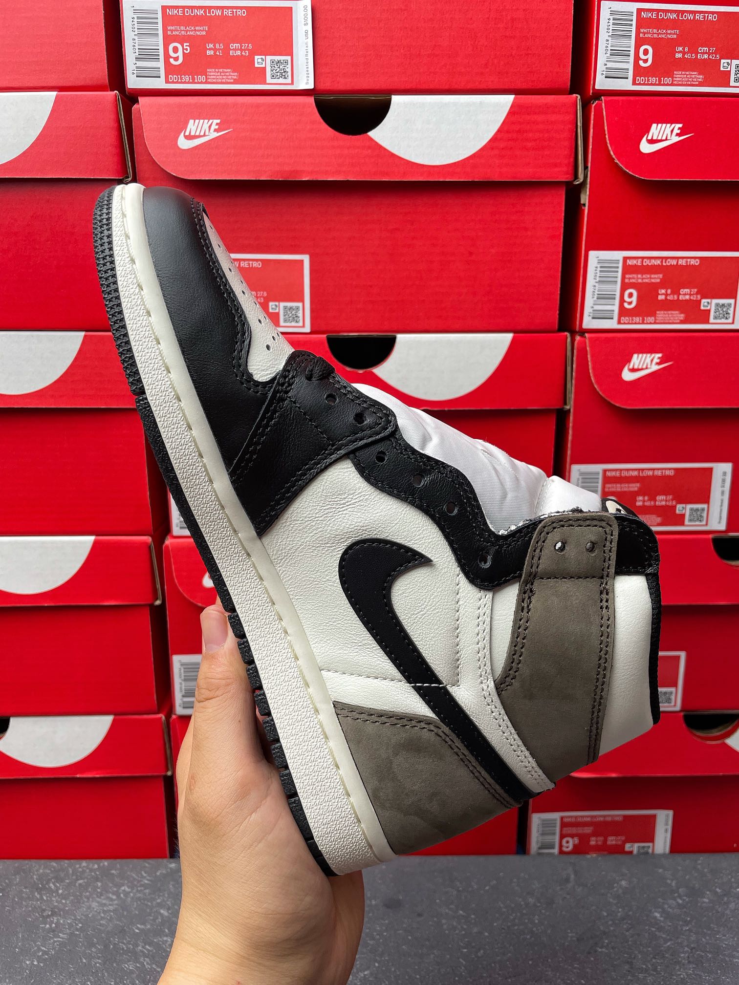 High-top sneakers, front three-quarter view, white panels with dark navy/black and tan suede
