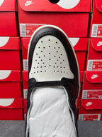 High-top sneakers, top of shoe view, perforated toe area with black laces and lining