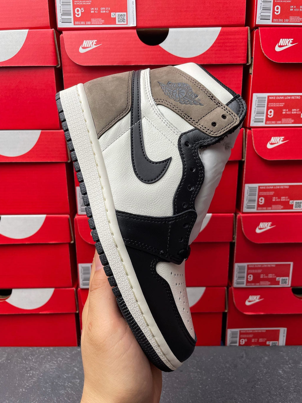 High-top sneakers, side view, white leather with dark navy/black swoosh and suede heel