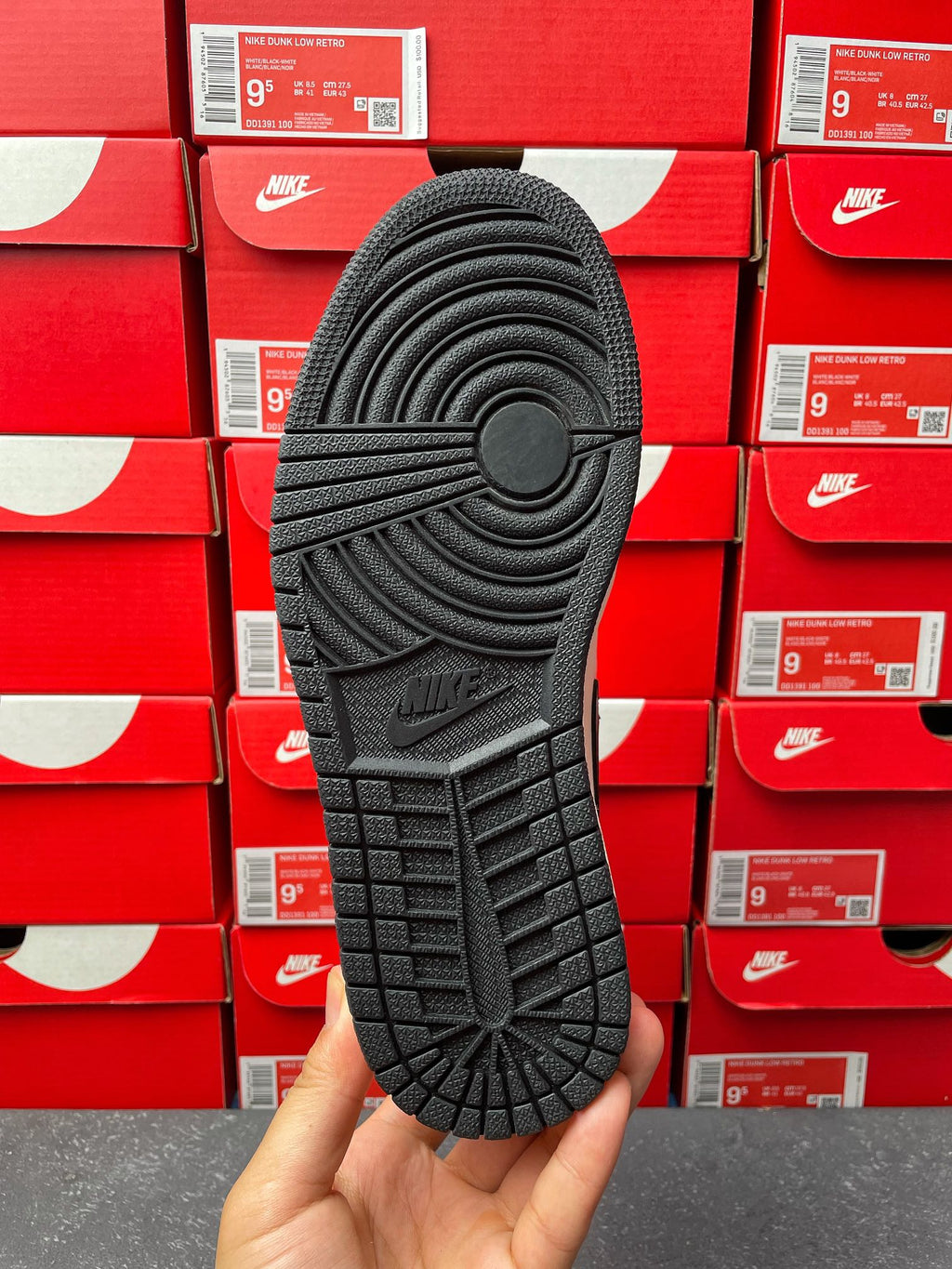 High-top sneakers outsole view, textured rubber tread with Nike logo branding