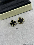 Van Cleef & Arpels quatrefoil stud earrings close-up, black enamel with gold outline