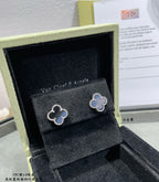 Van Cleef & Arpels quatrefoil stud earrings on velvet, light enamel with gold outline