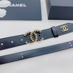 Chanel belt close-up: dark blue leather with gold-toned CC buckle and charm details