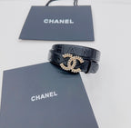 Chanel dark blue leather belt with gold-tone CC buckle and visible quilting on strap