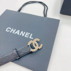 Chanel dark blue leather belt with gold-tone CC buckle on front, laid flat
