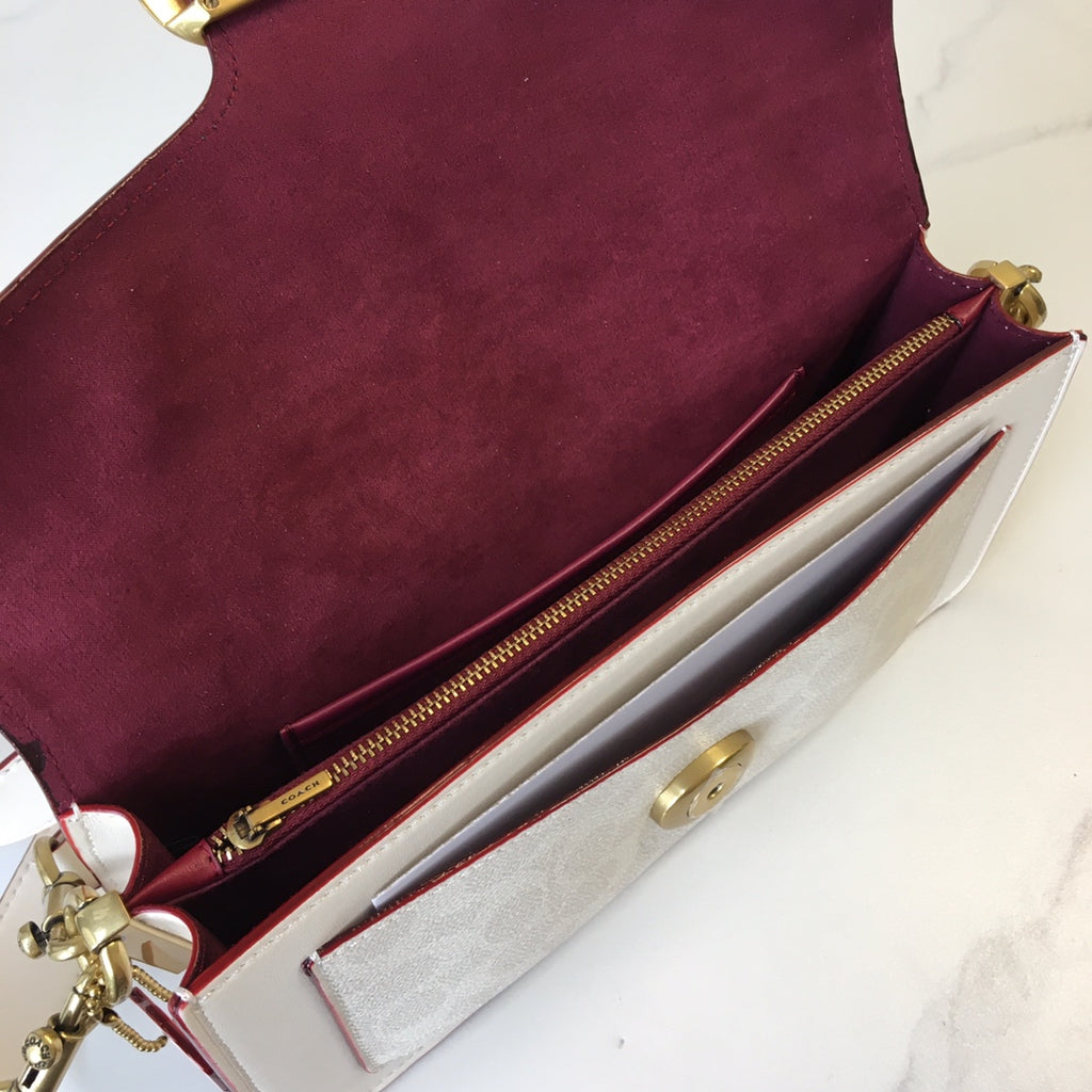 Coah bag interior view, burgundy lining, white compartment, gold zipper hardware