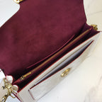 Coah bag interior view, burgundy lining, white compartment, gold zipper hardware