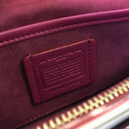 Coah bag interior label, burgundy lining with embossed patch and stitching